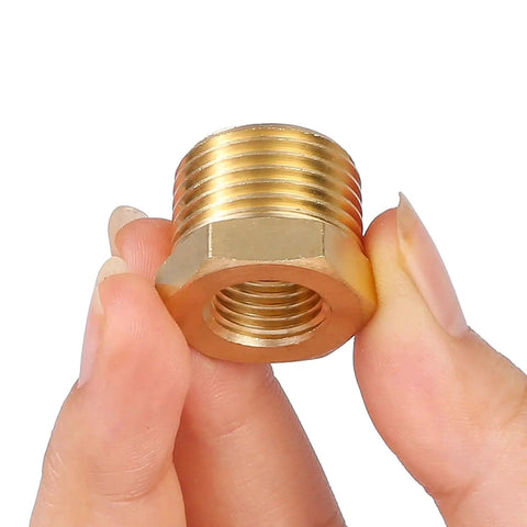 Brass NPT Reducer Bushing 1/2 Inch Male To 1/4 Inch Female Reducing Pipe Fitting close-up in hand