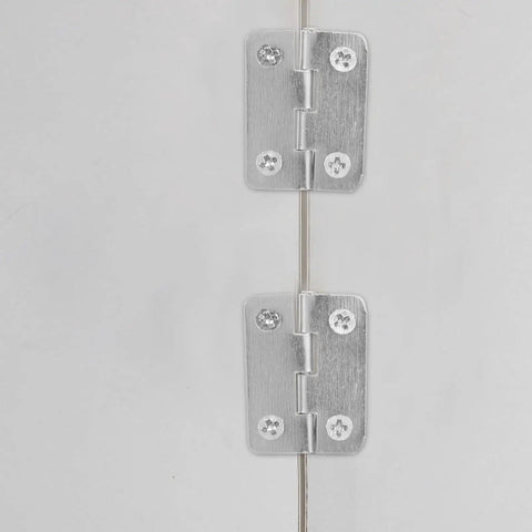 Close-up of 20 Piece Mini Hinge Set For DIY Projects And Handmade Crafts in silver iron, installed on a surface.