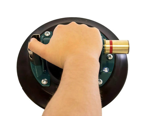 Hand gripping 9-Inch Metal Handle Suction Cup Lifter For Flat Surfaces, Heavy Duty 150 Lb Load Capacity, Green color in action