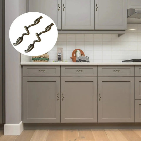 Leaf Shape Drawer Pull Handle Set In Vintage Bronze Finish installed on gray kitchen cabinets, showcasing twig branch design.
