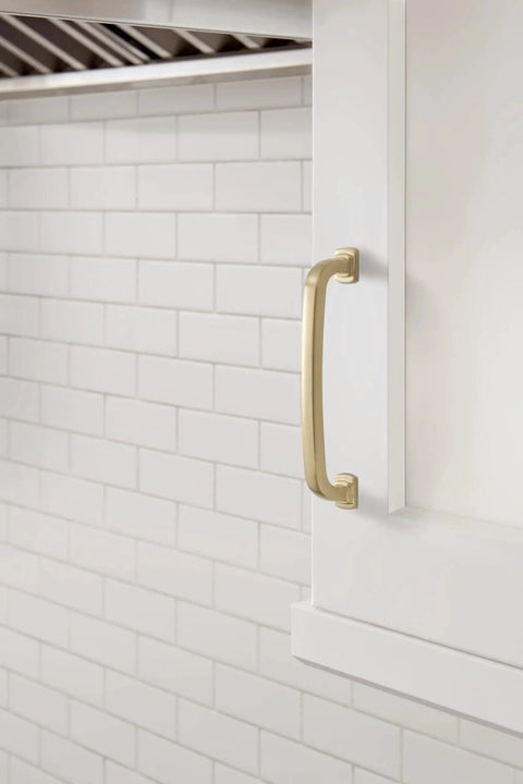 Side view of Champagne Bronze Surpass Cabinet Pull Five And One Sixteenth Inch Center To Center installed on white kitchen cabinet