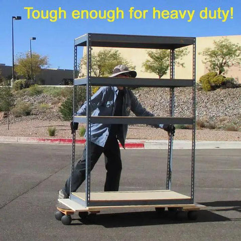 Person pushing metal shelving on wheels outdoors