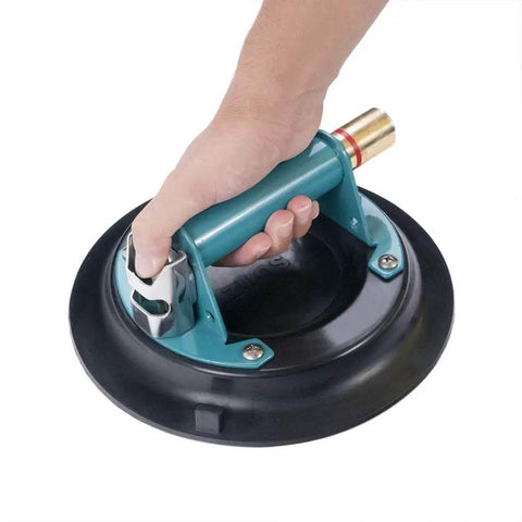 Hand holding 10 Inch Vacuum Suction Cup Lifter for Granite and Glass with Metal Handle and Brass Pump, durable rubber pad, close-up view