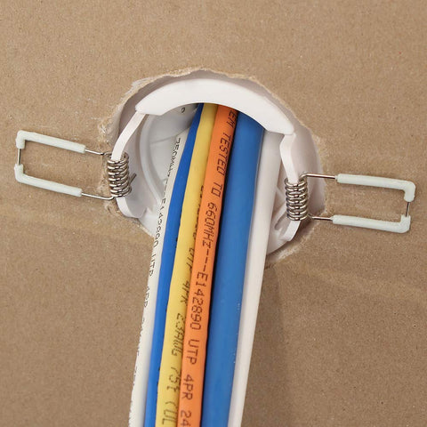 Speedy’Z 2-Inch Spring-Lock Cable Pass Port, white plastic wall grommet with metal springs and blue/yellow/orange cables