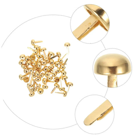 Close-up of 500-Piece DIY Craft Nails And Paper Fasteners Kit For Cards And Scrapbooking, golden miniature tacks and brads.