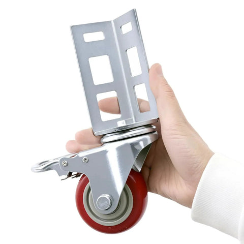 Close-up of a hand holding a Three Inch Caster Wheel for Boltless Shelving Racks, 500 lb load capacity, showing metal bracket and red wheel.