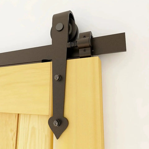 Close-up of a Two Pack Adjustable Barn Door Stopper for 40mm Flat Track Sliding Barn Door Hardware on a wooden door.