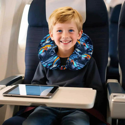 Boy on plane wears neck pillow matching Five Piece Kids Suitcase Set For Boys 18 Inch Truck Themed Carry On Luggage With Wheels.