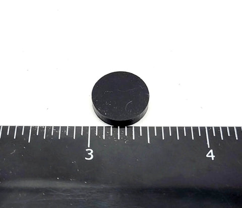 Half Inch Wide Round Silicone Rubber Bumper Feet Pads One Eighth Inch Thick With Adhesive Backing next to ruler for size reference
