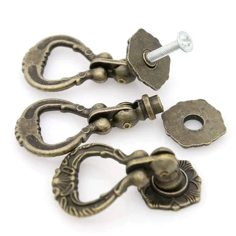 Set Of 4 Vintage Antique Brass Pendant Ring Pull Handles With Single Mounting Hole for drawers, close-up view showing screw detail.
