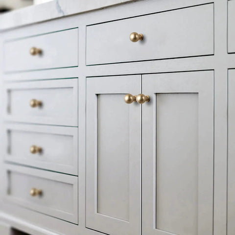 Close-up of furniture with Six Pack Zinc Alloy Drawer Knobs 0.94 Inch Diameter Champagne Bronze Cabinet Knobs in modern style installed.
