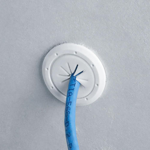 White Construct Pro Speedy’Z Mini cable pass-through port, 1.5 in outer, 1 in inner, blue Ethernet cable.