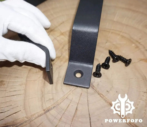 Heavy Duty Solid Steel Barn Door Handle And Closet Pull In Matte Black Powder Coat with screws, close-up view on wooden surface