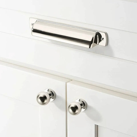 Front view of polished nickel cup pull installed on white cabinet, part of 10 Pack 2-1/2 Inch Polished Nickel Drawer Pulls Cabinet Cup Pulls Kitchen Hardware