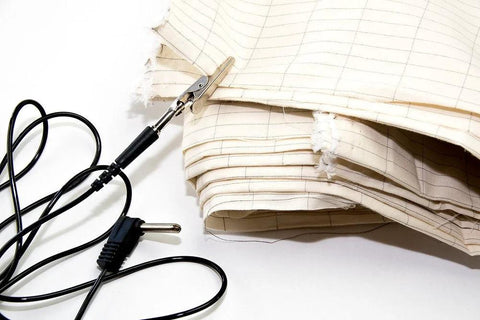 20-foot grounding cable with alligator clip and plug, shown beside beige EMF fabrics.