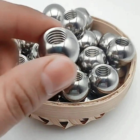 Stainless Steel Threaded Ball M8 Half Hole 15-60mm for DIY Projects held above a basket of identical balls.