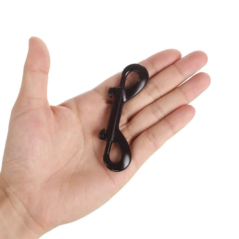 Double Ended Bolt Snap Hooks 3.5 Inch Black Zinc Alloy 4 Pack shown in hand for size comparison.