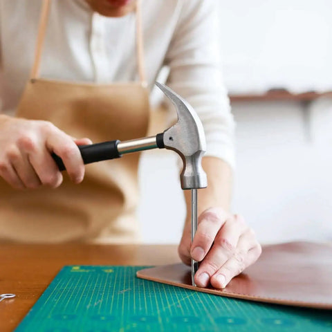 Person using Eight Size Leather Oval Hole Punch Kit 2mm To 5mm Pro Grade Hollow Punch Tool Set on leather craft project
