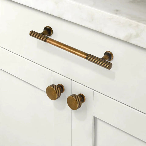 Antique Brass Kitchen Cabinet Knobs 10 Pack Zinc Drawer Pulls installed on white cabinets in kitchen