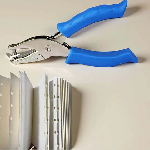 Photo of Blue One Circle Hole Punch With Soft Grip Handheld Paper Punch for crafts and card making next to punched paper samples