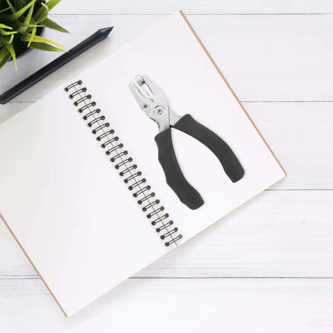 Metal Single Hole Puncher With Ergonomic Handles And Built In Guide For Home Office Crafts on a notebook