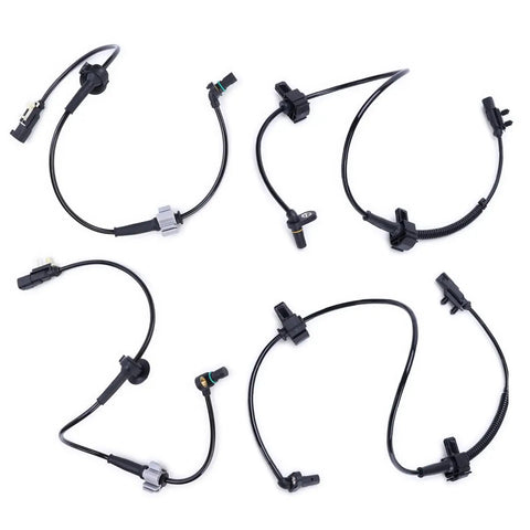Set of four black ABS wheel speed sensors with wiring harnesses and connectors.