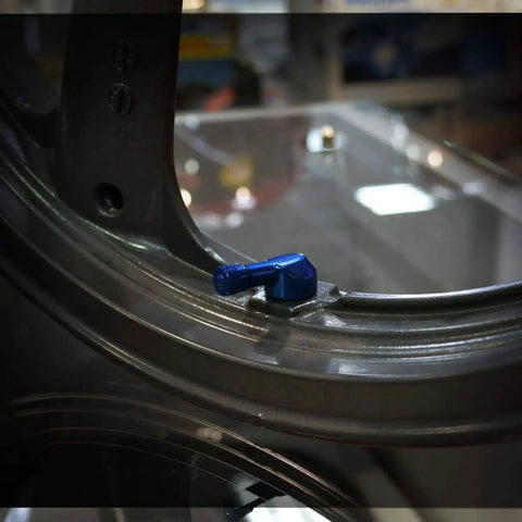 Installed Angled Valve Stem Set With Pre Applied Threadlocker Nut Forged Aluminum Construction 0.357 Inch (8.3mm) Size Blue Finish