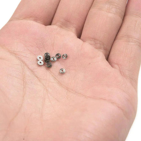 681ZZ 10-Pack Mini Metal Shielded Deep Groove Ball Bearings 3×7×3 mm resting on a hand, showing size and detail.
