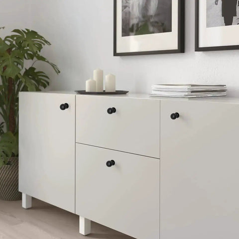 Matte Black Cabinet Knobs Four Pack with Wide Backplates on white dresser in modern living room
