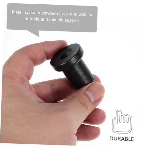 Hand holding a single iron spacer from the 4 Pack Barn Door Track Spacers Built Tough With Sturdy Carbon Steel Connectors For Sliding Doors