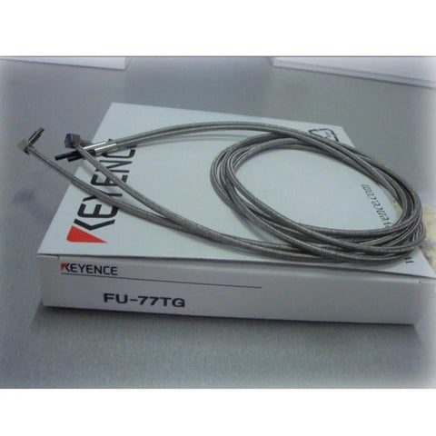 Keyence FU-77TG Transmissive Fiber Optic Sensor Switch Unit on packaging box, industrial automation component.