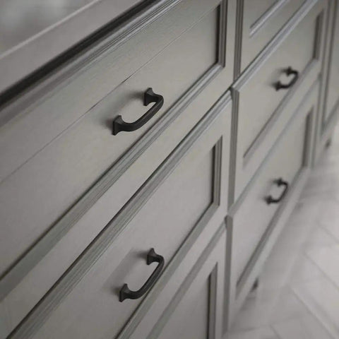 Lombard 3 Inch Center To Center Matte Black Cabinet Handles on gray dresser drawers for modern hardware update.