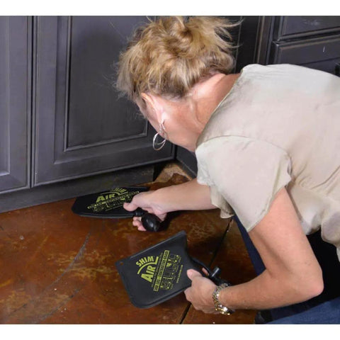 Woman using Inflatable Air Shim Pry Bar And Leveling Tool For Window Door And Cabinet Installations 300 LB Capacity Pro Grade Contractor Wedge