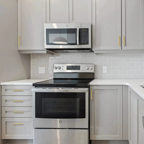 Modern kitchen with 30 Pack 5 Inch Square Cabinet Handles In Brushed Brass Finish Stainless Steel Kitchen Hardware Pulls With 128mm Hole Center Designed For Cabinets Wardrobes Chests And Cupboards Gold, installed on grey cabinets.
