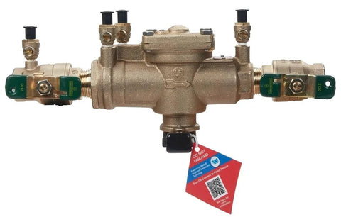 Watts 009-QT 1-inch RPZ backflow preventer for lawn irrigation, brass body with green end valves.