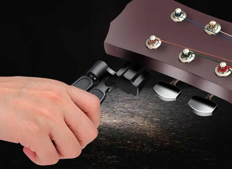 Guitar String Winder Cutter And Pin Puller 3 In 1 Must Have Multifunctional Maintenance Tool in use on a guitar headstock
