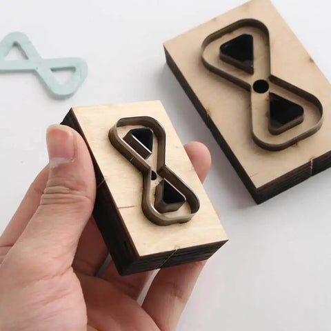 Dope Bow Shape Leather Cutting Die Set Two Pack For DIY Leather Projects with wooden frame and Japanese steel blades shown in hand