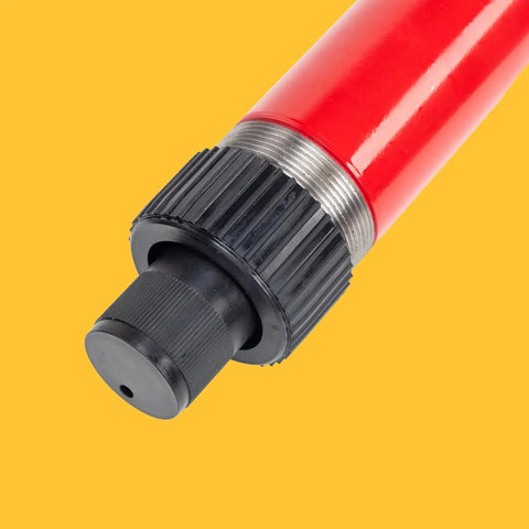 Close-up of red and black 10 Ton Hydraulic Floor Jack Pump Portable Ram For Auto Body And Frame Repair on yellow background