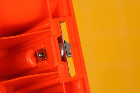 Close-up of blade in red Mat Board Cutter 45 Degree Bevel For Precise Framing Aluminum Die Cast Grip NT Professional MAT45P with yellow background.