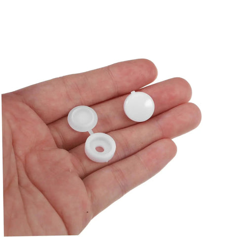 Hand holding white caps from Plastic Screw Cover Caps Set 400 Pieces Hinged Design Multi Color Assorted For Furniture Tables And Cabinets