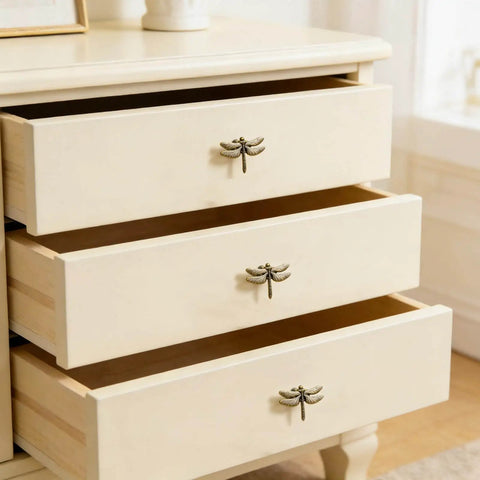 Dragonfly Drawer Knobs Set 6 Pieces in Ancient Gold installed on light-colored dresser drawers, showing realistic wing detail.