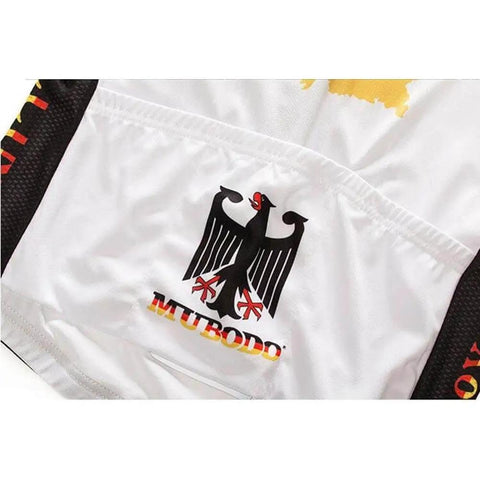 Close-up of a white cycling jersey featuring a black eagle emblem and the word 'MUBODO' in red and yellow.