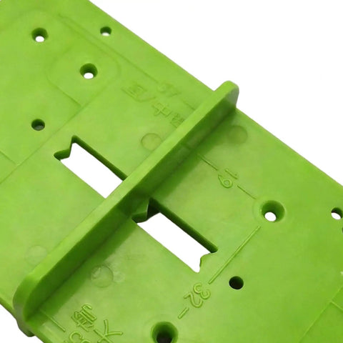 Close-up of green 35mm Hinge Template Router Jig For Cabinets Drawers And Furniture Doors with guide and adjustable stops