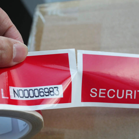 Tamper-evident security tape roll, red with white serial-number label and 6-inch perforations