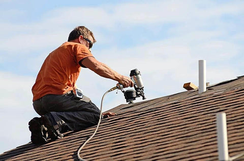 Worker on roof using pneumatic tool; ideal use for AirAid Air Tool Conditioner, Protective Coating, And Rust Inhibitor For Tools.