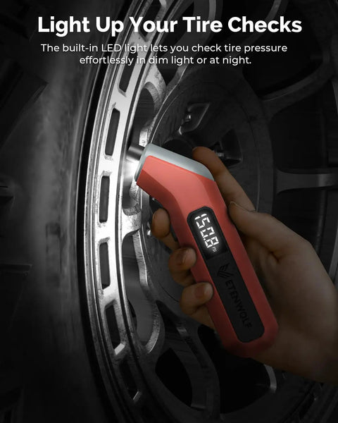Digital Tire Pressure Gauge T300 3-200 PSI Calibrated to ANSI B40.7 Grade 2A With Replaceable AAA Batteries In Vivid Orange held up against a car wheel.