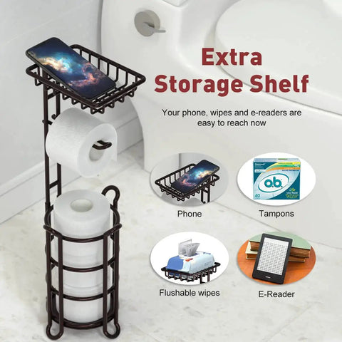 Free Standing Toilet Paper Holder Stand Dispenser With Top Shelf For Bathroom Storage, Bronze Finish, next to a toilet