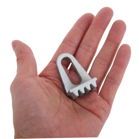 Engine flywheel lock tool, silver metal with serrated teeth, held in a hand