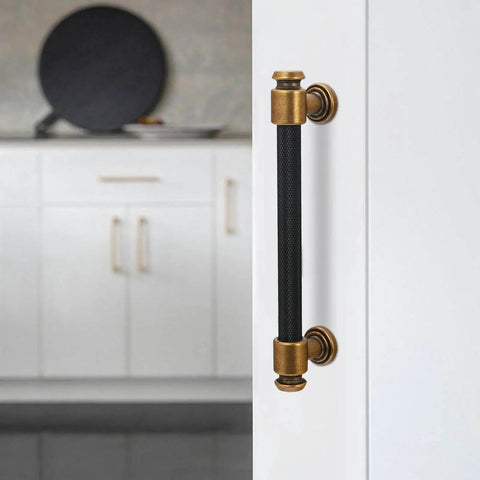 Close-up of 10 Pack 5 Inch Black And Antique Brass Kitchen Cabinet Handles Knurled Cabinet Pulls on white cabinet door