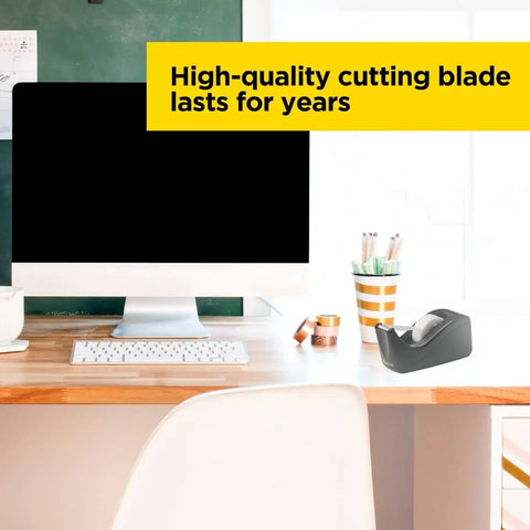 Deluxe Black Desktop Tape Dispenser With Weighted Non Skid Base on desk beside computer and stationery